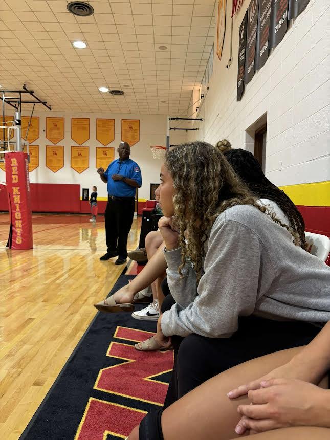 Senior varsity volleyball manager Lauren Buchanan watches varsity match against Incarnate Word Academy

