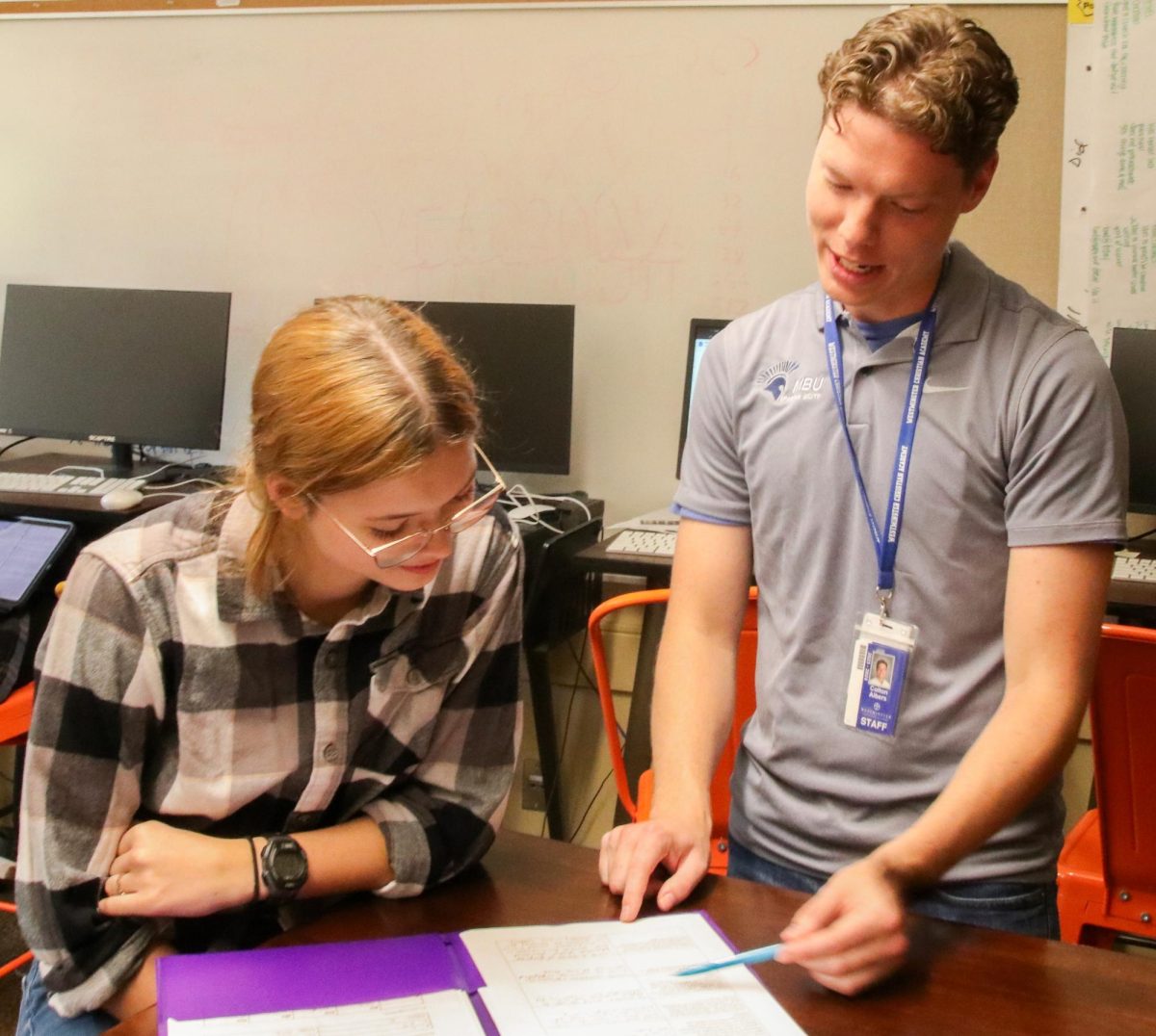 Colton Albers assists struggling student with a difficult homework assignment.