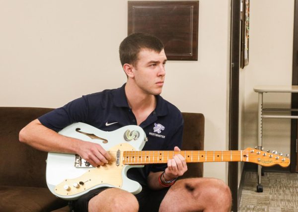 Shepherd Perkins plays bass guitar while thinking about his music. 