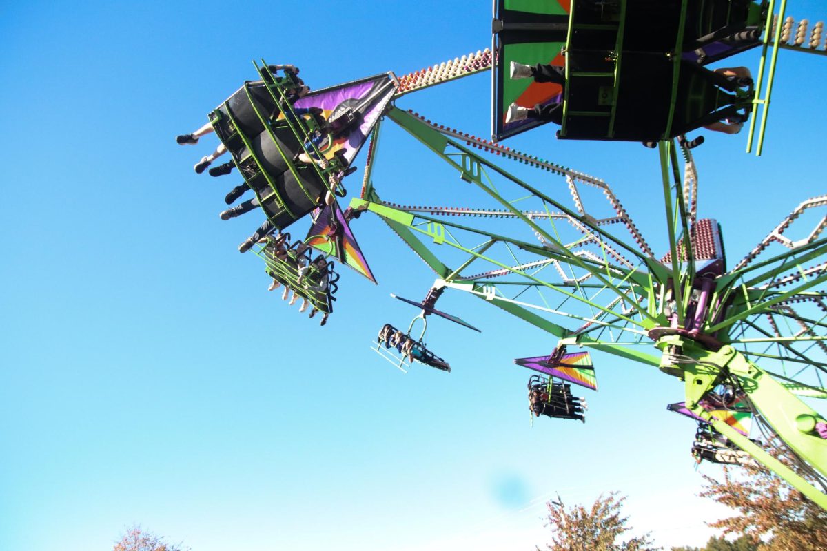 Carnival Attendees Enjoy a Fun Experience on the Hang-Glider Ride