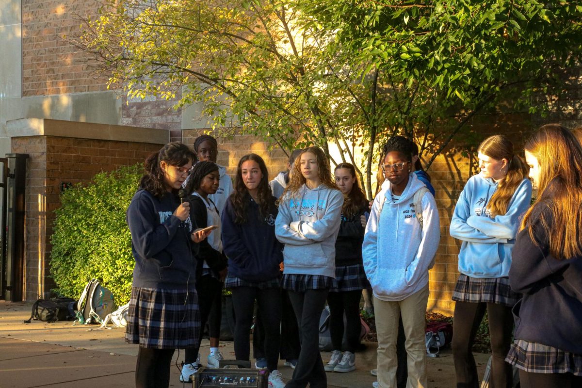 A group of Senior girls listen intently to the faculty speaker.