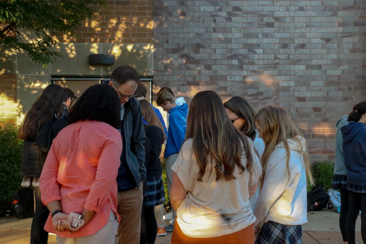 Matt Seilback, Upper School Bible Teacher, leads a small group of women in prayer.