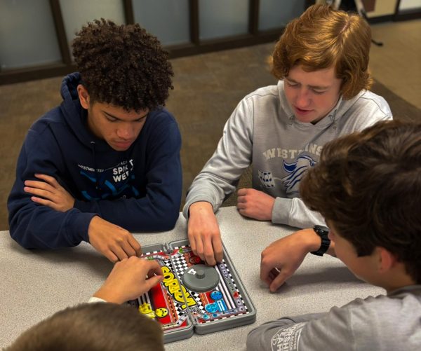 Four Students Enjoy a Common Table Top Game Called Sorry