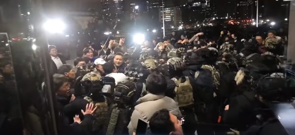 Civilians come into contact with soldiers in South Korea 2024 martial law protests.