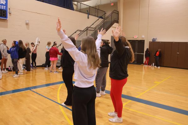 The Senior Girls Stretching as they Warm Up to Practice Their Wicked Themed Lip Sync Routine