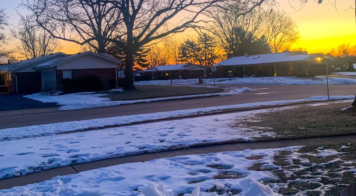 The Sun Rises Over Melting Snow in a Neighborhood in The Morning