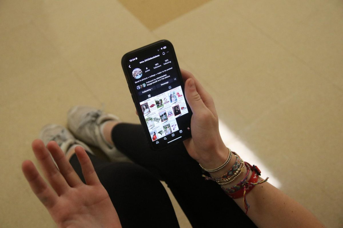 A student holding a class decisions page instagram 